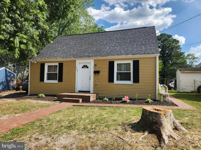 a backyard of a house with yard and outdoor seating