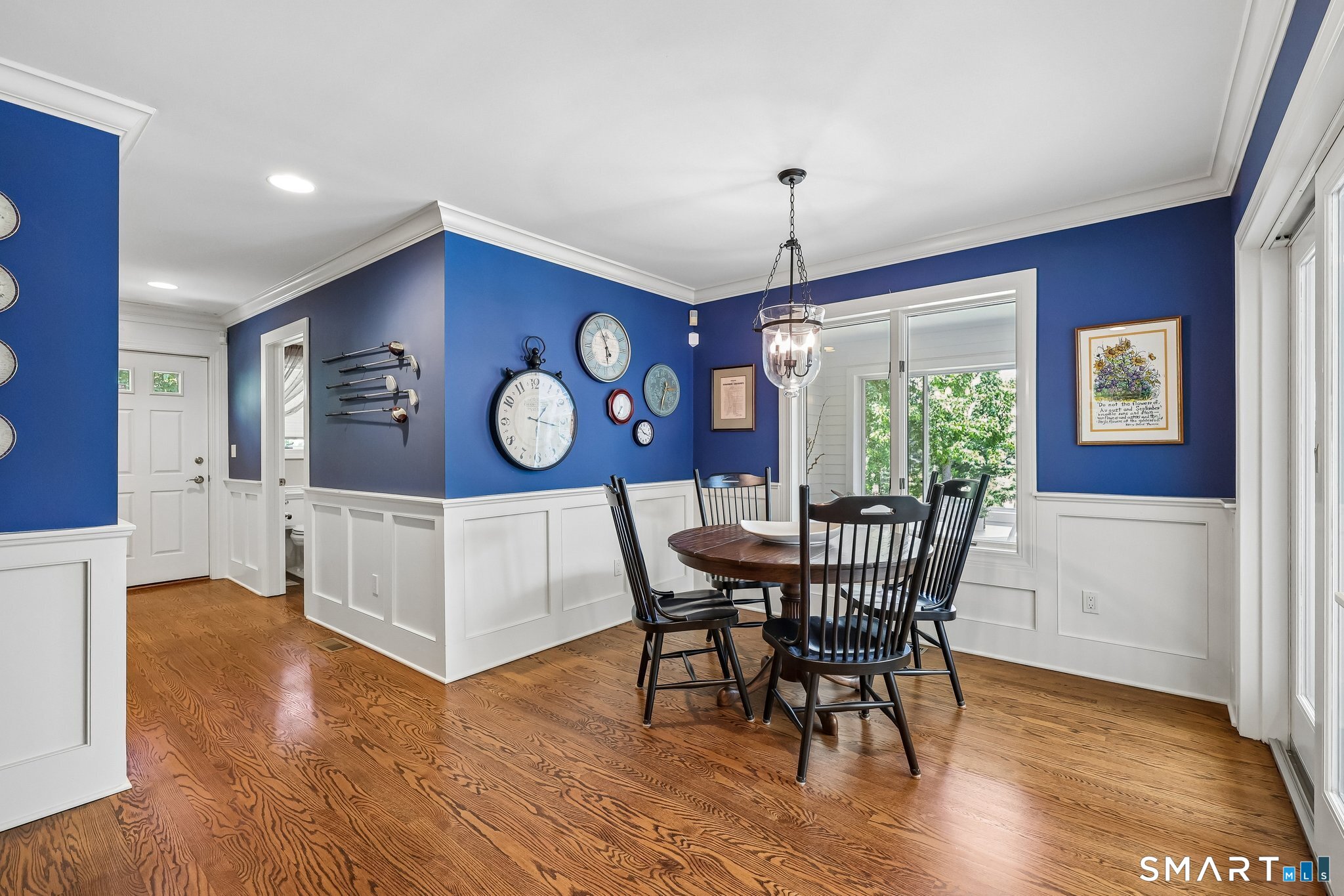 72 Strawberry Hill Road Madison, CT 06443 - Photo 13 of 40 This cozy casual eating nook has wood panels and crown molding. Down the hall is a mud room and entry to the three car garage. Sliders to the sunroom are across from this dining area