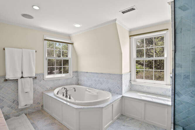 40 Tulip Tree Lane Darien, CT 06820 - Photo 14 of 27 a bathroom with a bathtub and window