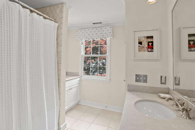 40 Tulip Tree Lane Darien, CT 06820 - Photo 16 of 27 a bathroom with a sink and a mirror