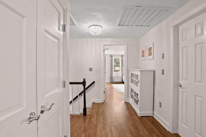 40 Tulip Tree Lane Darien, CT 06820 - Photo 19 of 27 a view of a hallway with wooden floor and staircase