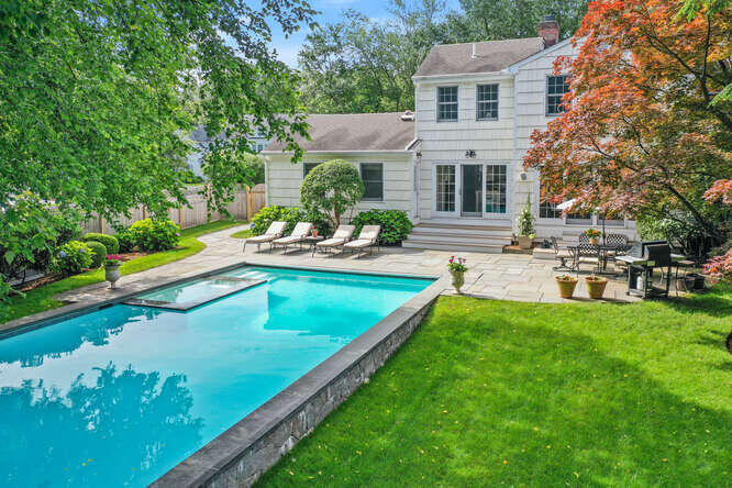 40 Tulip Tree Lane Darien, CT 06820 - Photo 24 of 27 a view of a house with swimming pool and sitting area