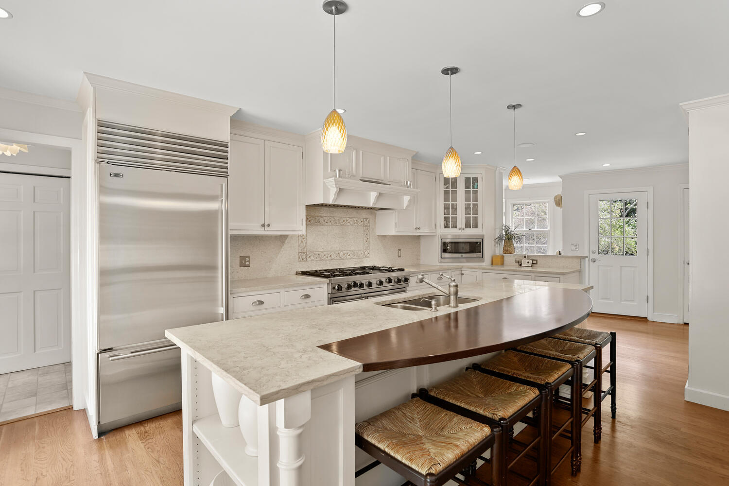 40 Tulip Tree Lane Darien, CT 06820 - Photo 6 of 27 a kitchen with a stove a refrigerator a sink dishwasher with a dining table and chairs