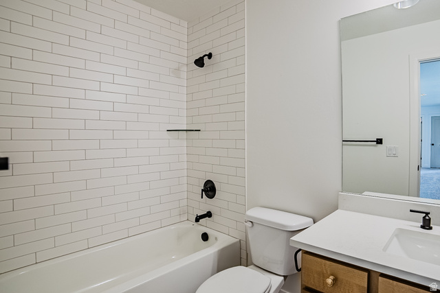 223 South Cottonwood Road, Unit 7501 Vineyard, UT 84059 - Photo 18 of 45 Bathroom featuring a white subway tile shower surround with matte black fixtures and a built-in shelf