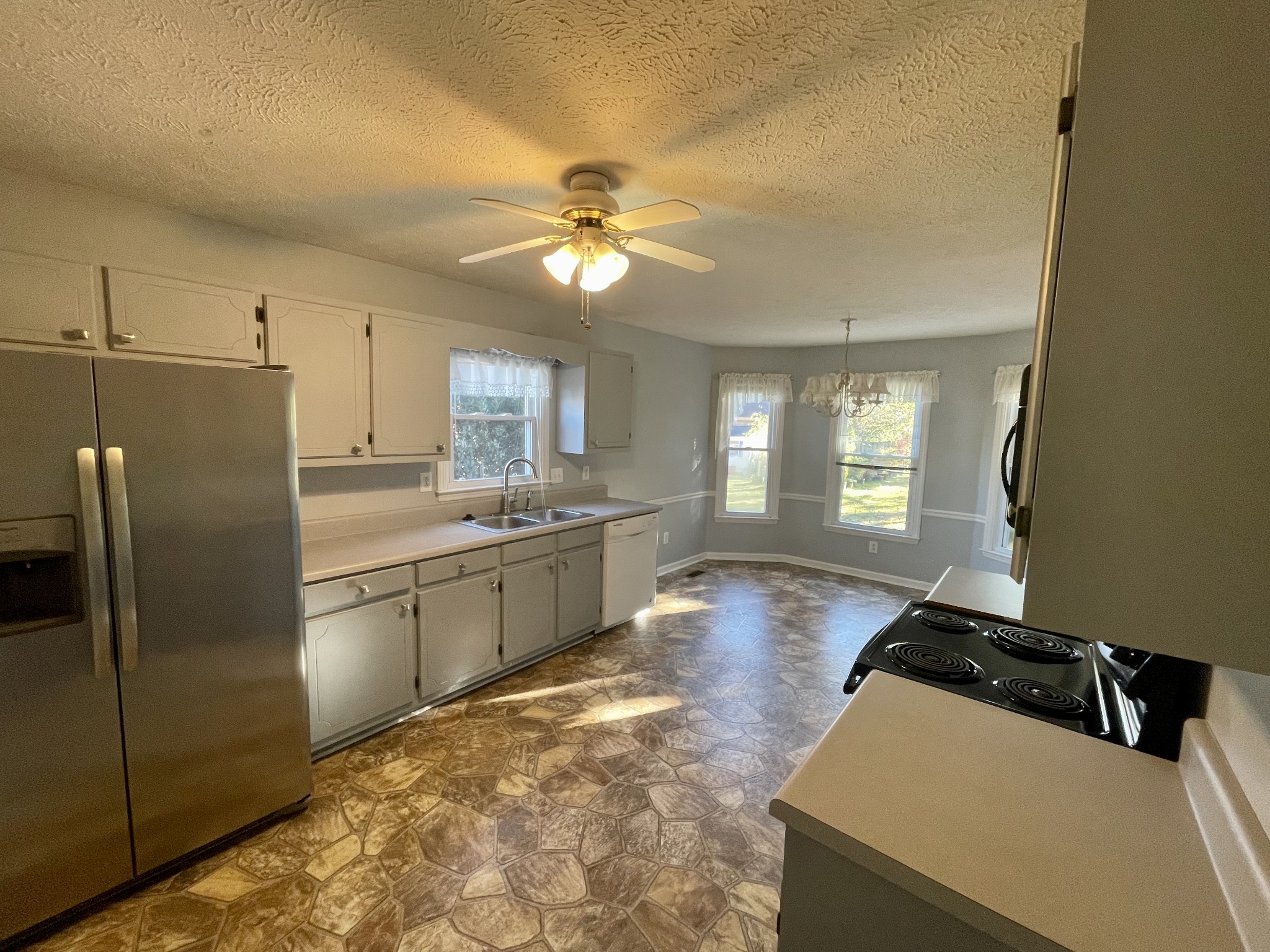 3114 Chanda Lane Murfreesboro, TN 37129 - Photo 6 of 12 a kitchen with stainless steel appliances sinks a refrigerator and white cabinets