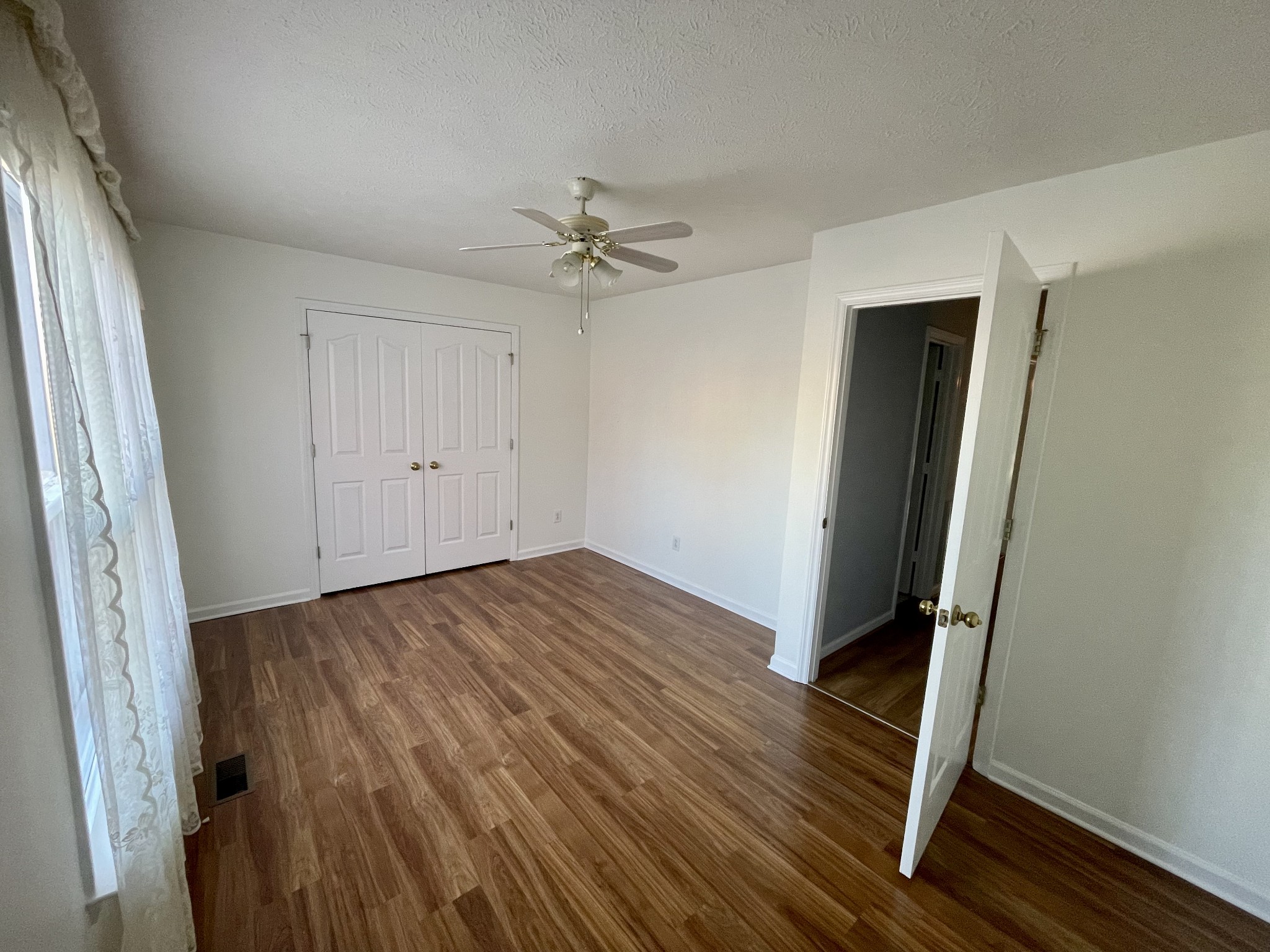 3114 Chanda Lane Murfreesboro, TN 37129 - Photo 7 of 12 an empty room with wooden floor and ceiling fan