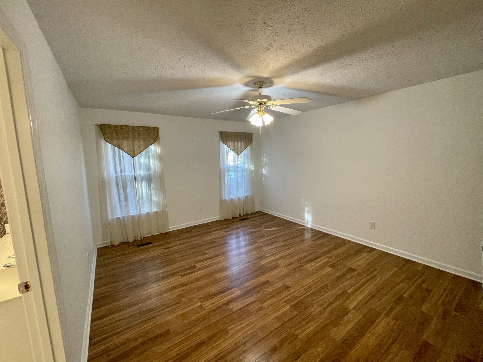 3114 Chanda Lane Murfreesboro, TN 37129 - Photo 10 of 12 an empty room with wooden floor and windows