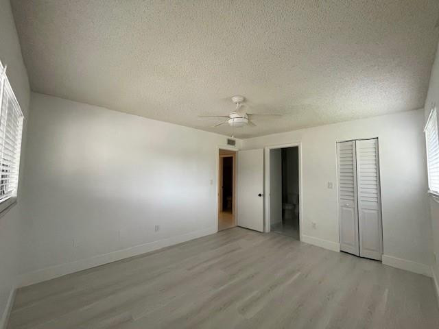 9499 West McNab Road, Unit 208 Tamarac, FL 33321 - Photo 14 of 19 an empty room with an entryway and chandelier fan