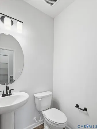 a brick house that has a big yard in front of it