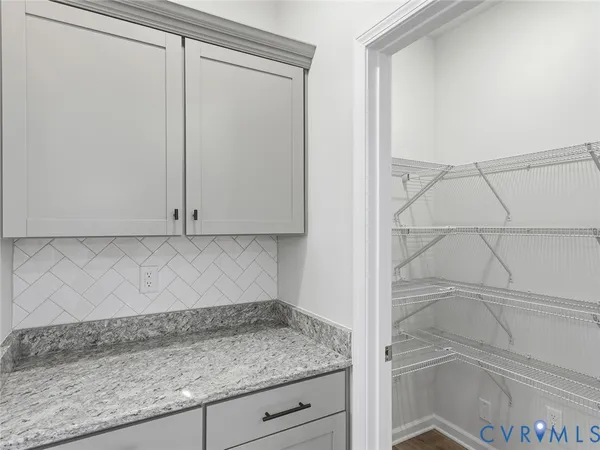 a kitchen with stainless steel appliances granite countertop a sink a refrigerator a center island and a window