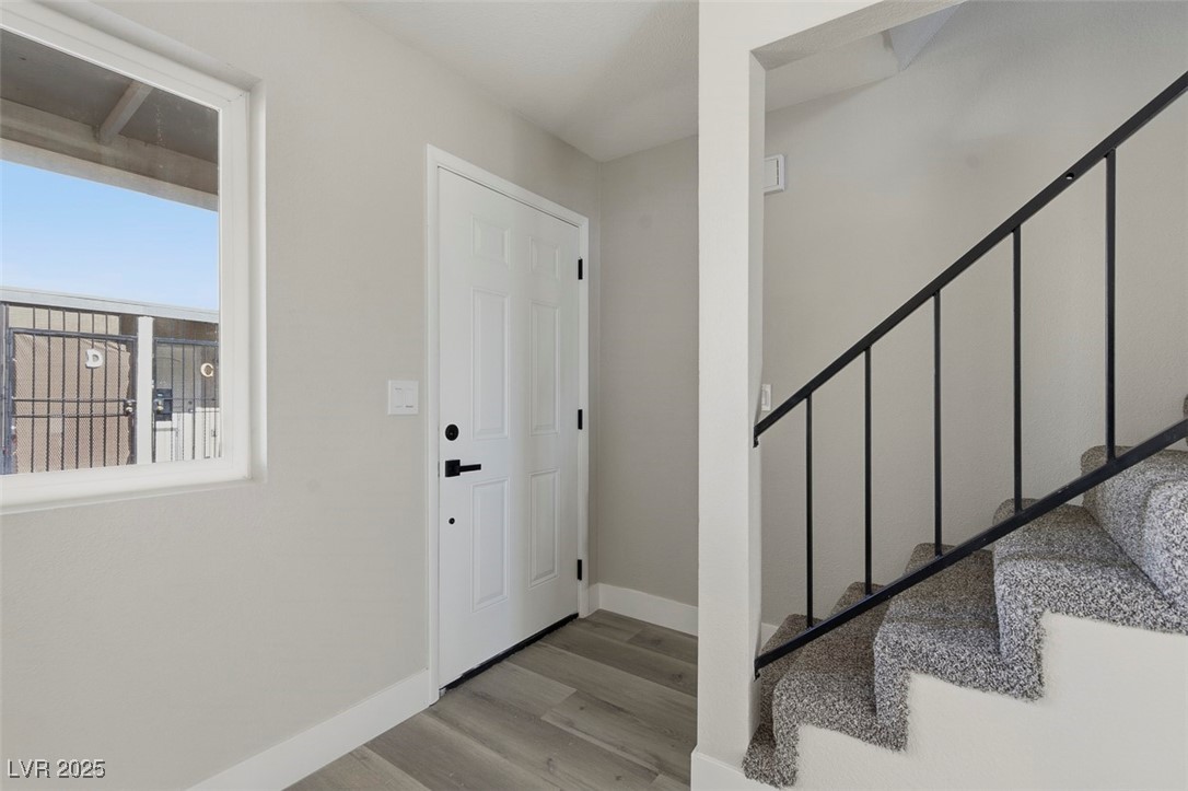 3517 Rio Robles Drive, Unit D North Las Vegas, NV 89030 - Photo 8 of 35 Foyer entrance with stairs and light wood-style flooring