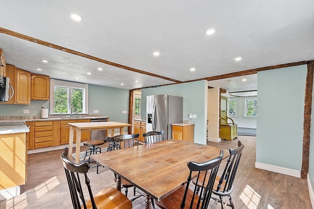230 7 Bridge Road Lancaster, MA 01523 - Photo 15 of 33 a dining room with a table chairs and kitchen view