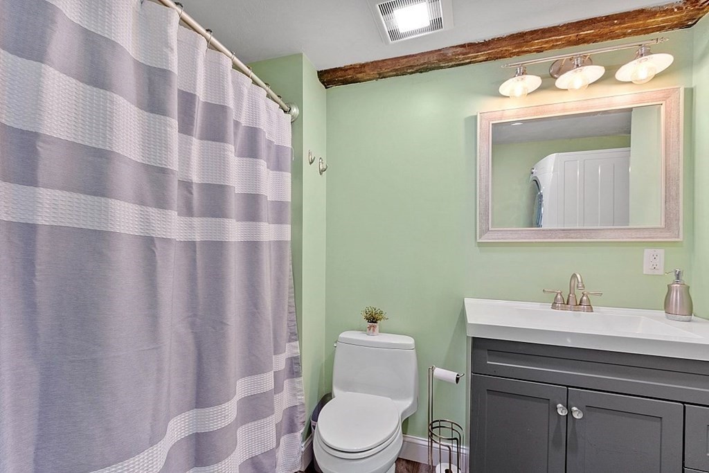 230 7 Bridge Road Lancaster, MA 01523 - Photo 22 of 33 a bathroom with a sink a toilet and a mirror