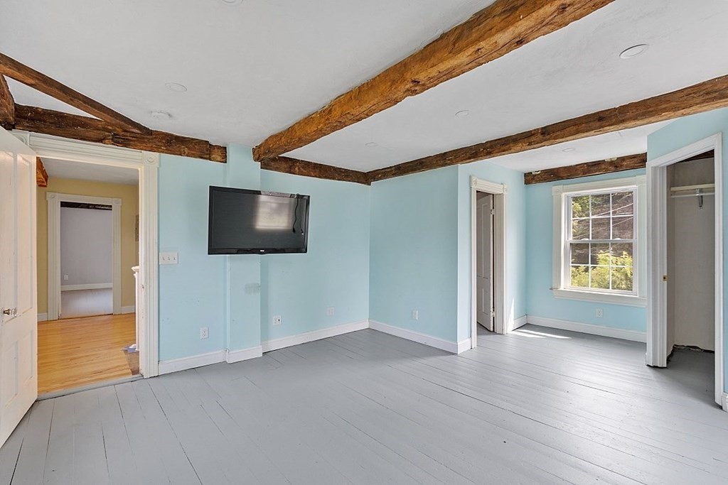 230 7 Bridge Road Lancaster, MA 01523 - Photo 26 of 33 a view of an empty room with a window and wooden floor