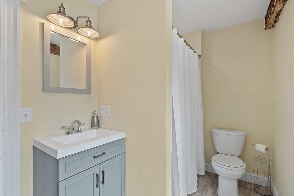 230 7 Bridge Road Lancaster, MA 01523 - Photo 29 of 33 a bathroom with a sink a toilet and a mirror