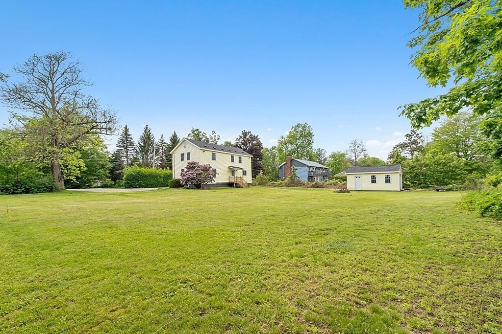 230 7 Bridge Road Lancaster, MA 01523 - Photo 6 of 33 a front view of a house with a yard