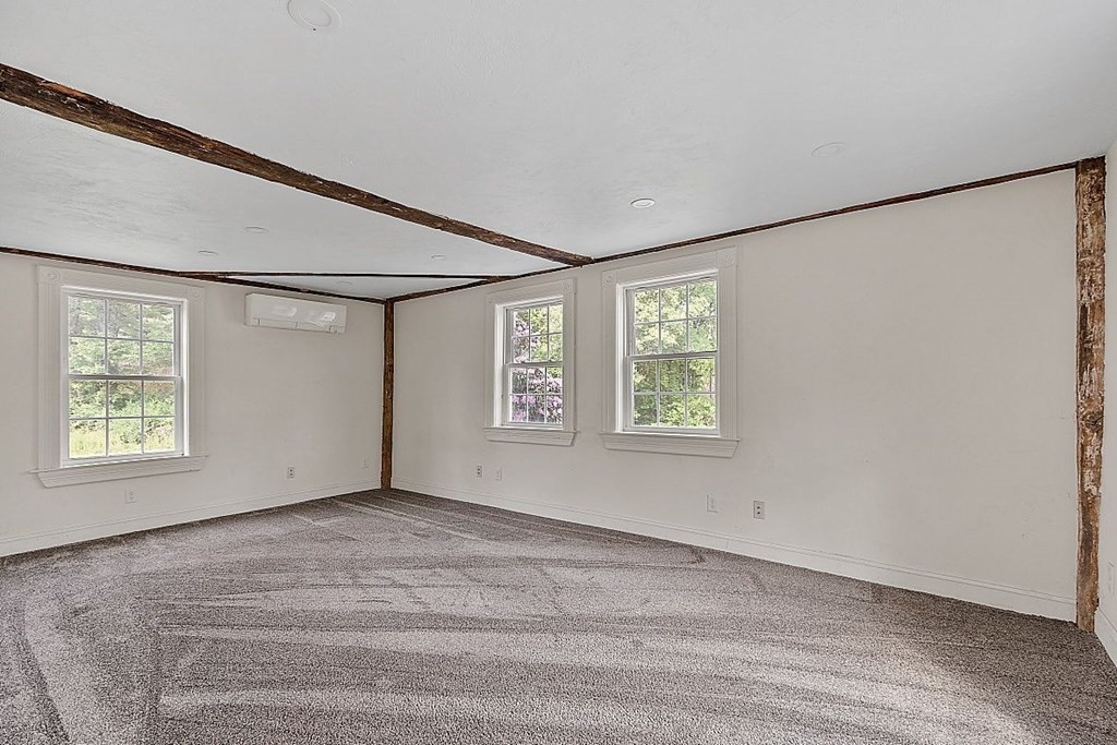 230 7 Bridge Road Lancaster, MA 01523 - Photo 10 of 33 a view of an empty room with a window