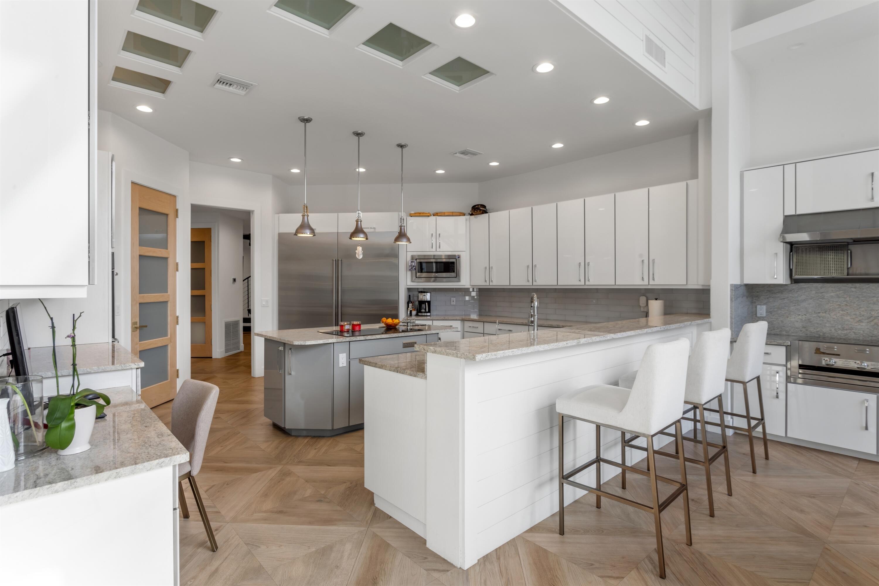 4698 Sanctuary Lane Boca Raton, FL 33431 - Photo 17 of 43 a kitchen with refrigerator and chairs