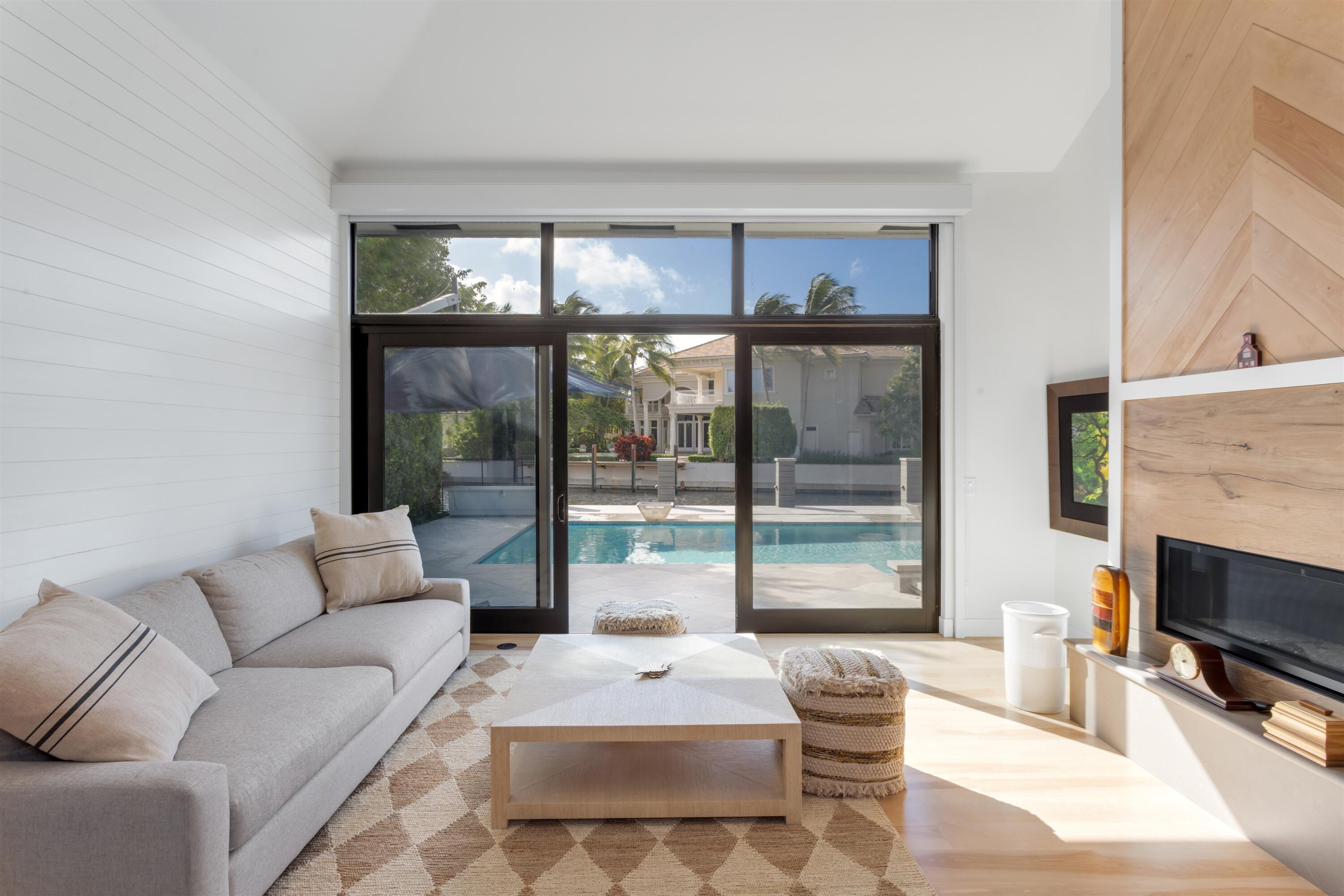4698 Sanctuary Lane Boca Raton, FL 33431 - Photo 21 of 43 a living room with furniture a large window and a fireplace