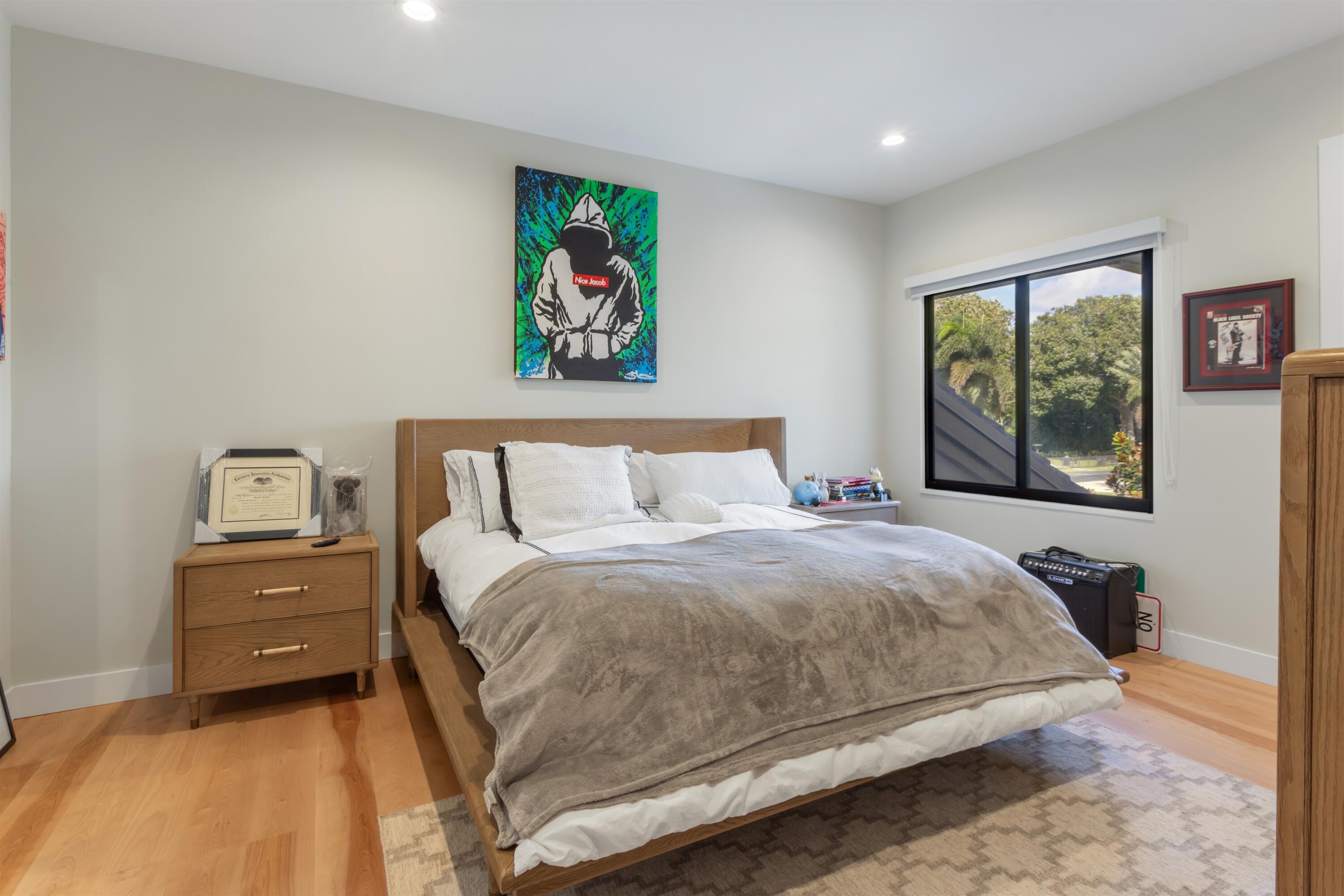 4698 Sanctuary Lane Boca Raton, FL 33431 - Photo 30 of 43 a bedroom with a bed and a painting on the wall