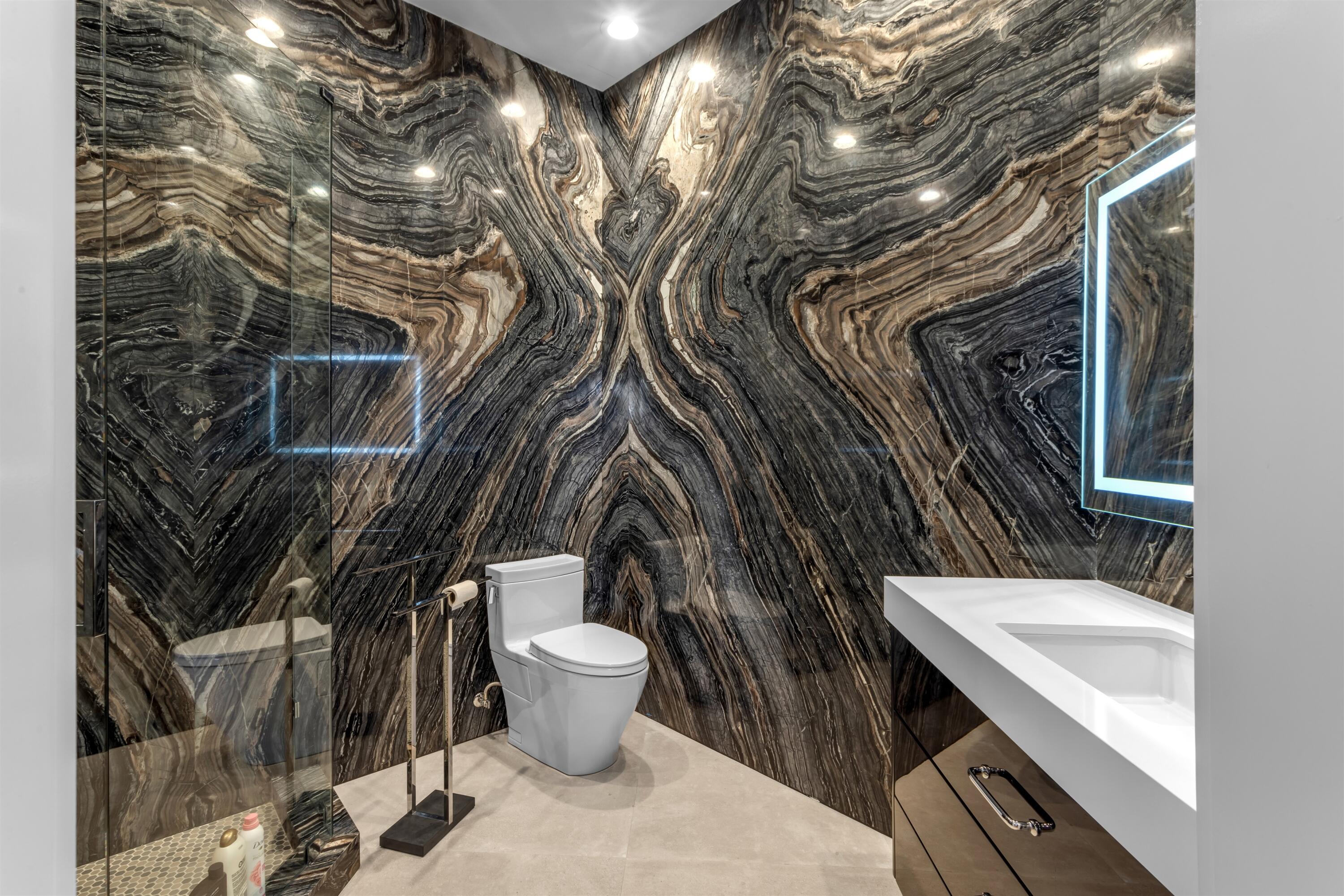 4698 Sanctuary Lane Boca Raton, FL 33431 - Photo 31 of 43 a bathroom with a toilet sink and mirror