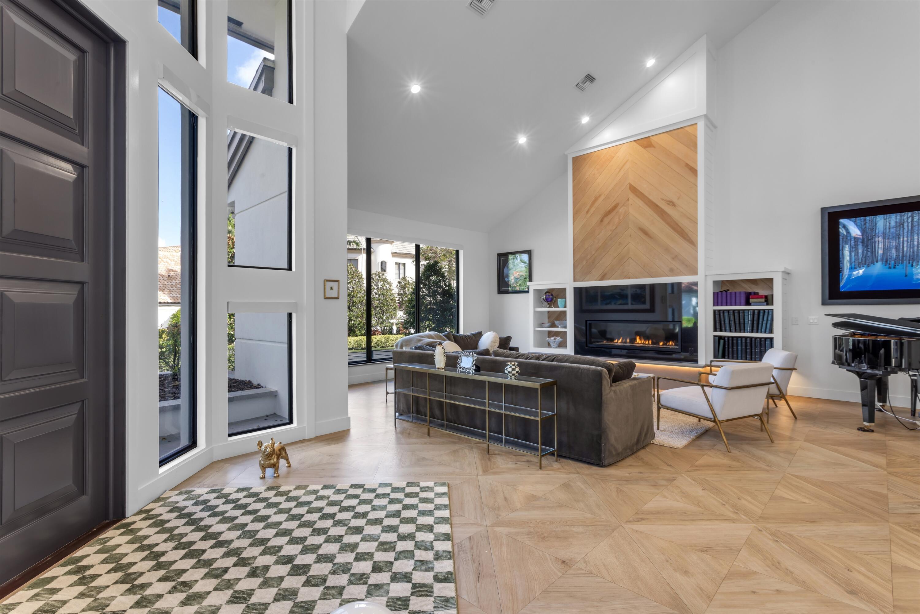 4698 Sanctuary Lane Boca Raton, FL 33431 - Photo 6 of 43 a living room with furniture a rug and a fireplace