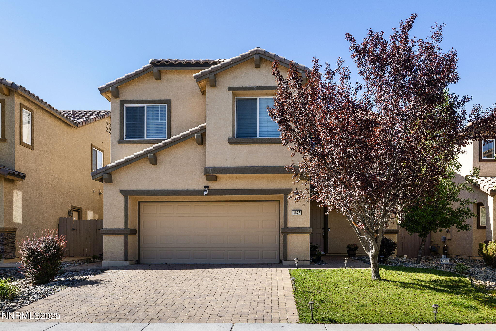 1876 Braemore Drive Reno, NV 89521 - Photo 1 of 34 a front view of a house with a yard and garage