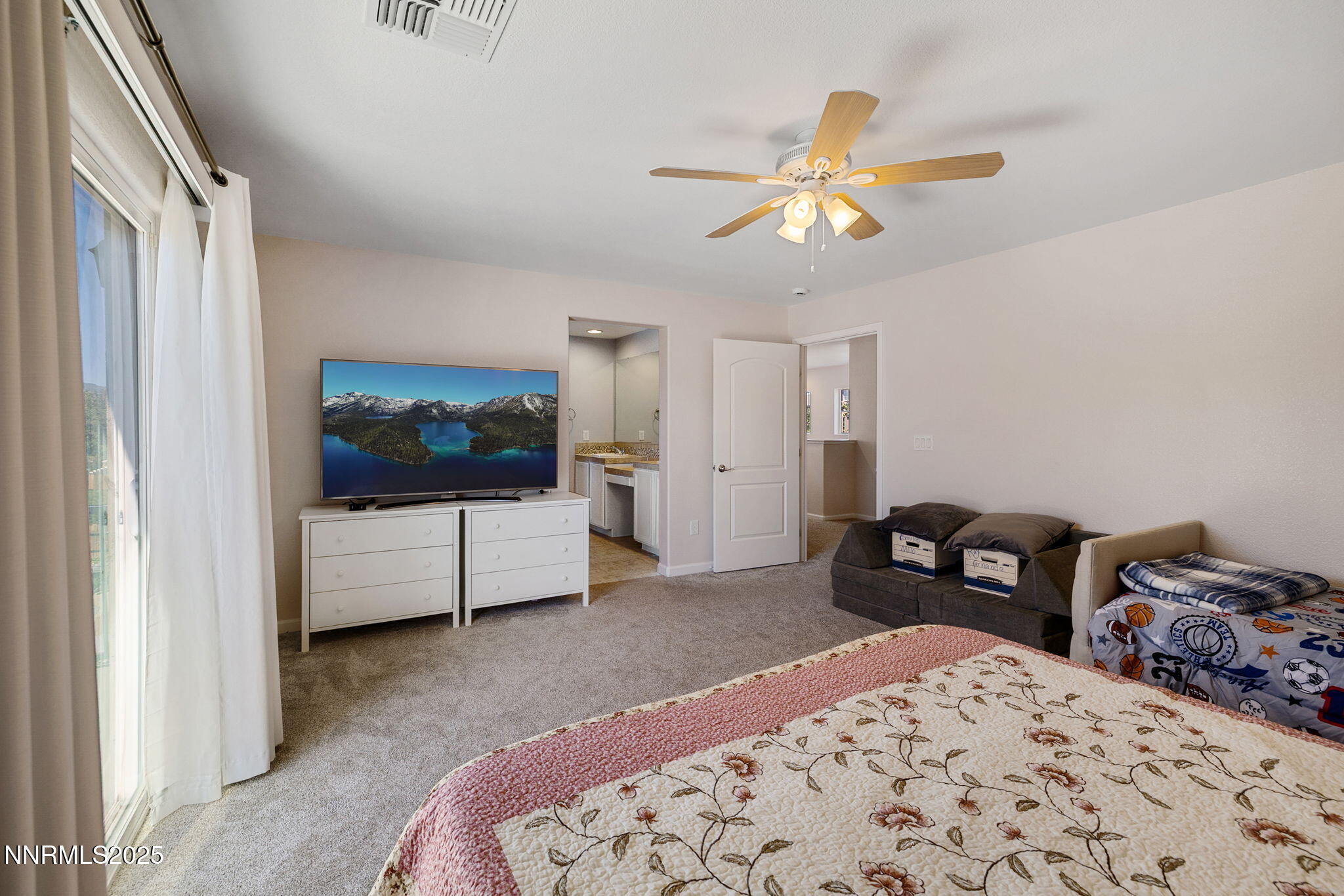 1876 Braemore Drive Reno, NV 89521 - Photo 15 of 34 a bedroom with a bed and a chandelier