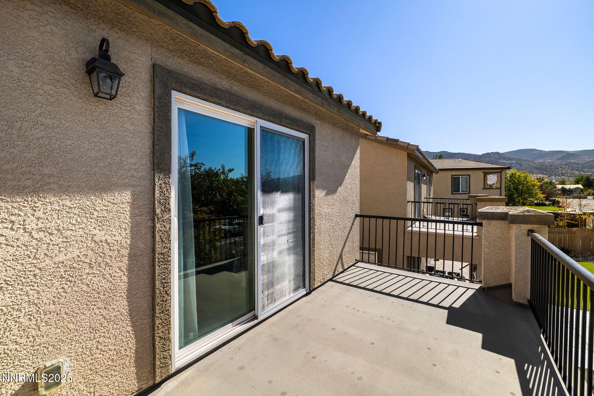 1876 Braemore Drive Reno, NV 89521 - Photo 17 of 34 a view of a balcony with a barbeque grill and floor to ceiling window
