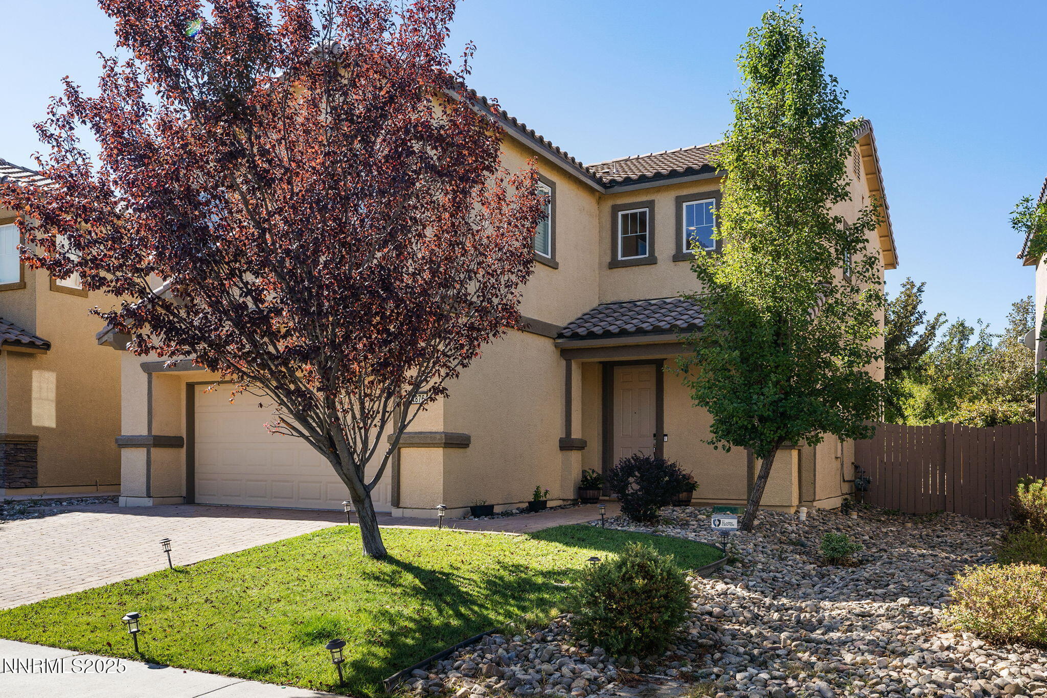 1876 Braemore Drive Reno, NV 89521 - Photo 2 of 34 a front view of a house with a yard and garage
