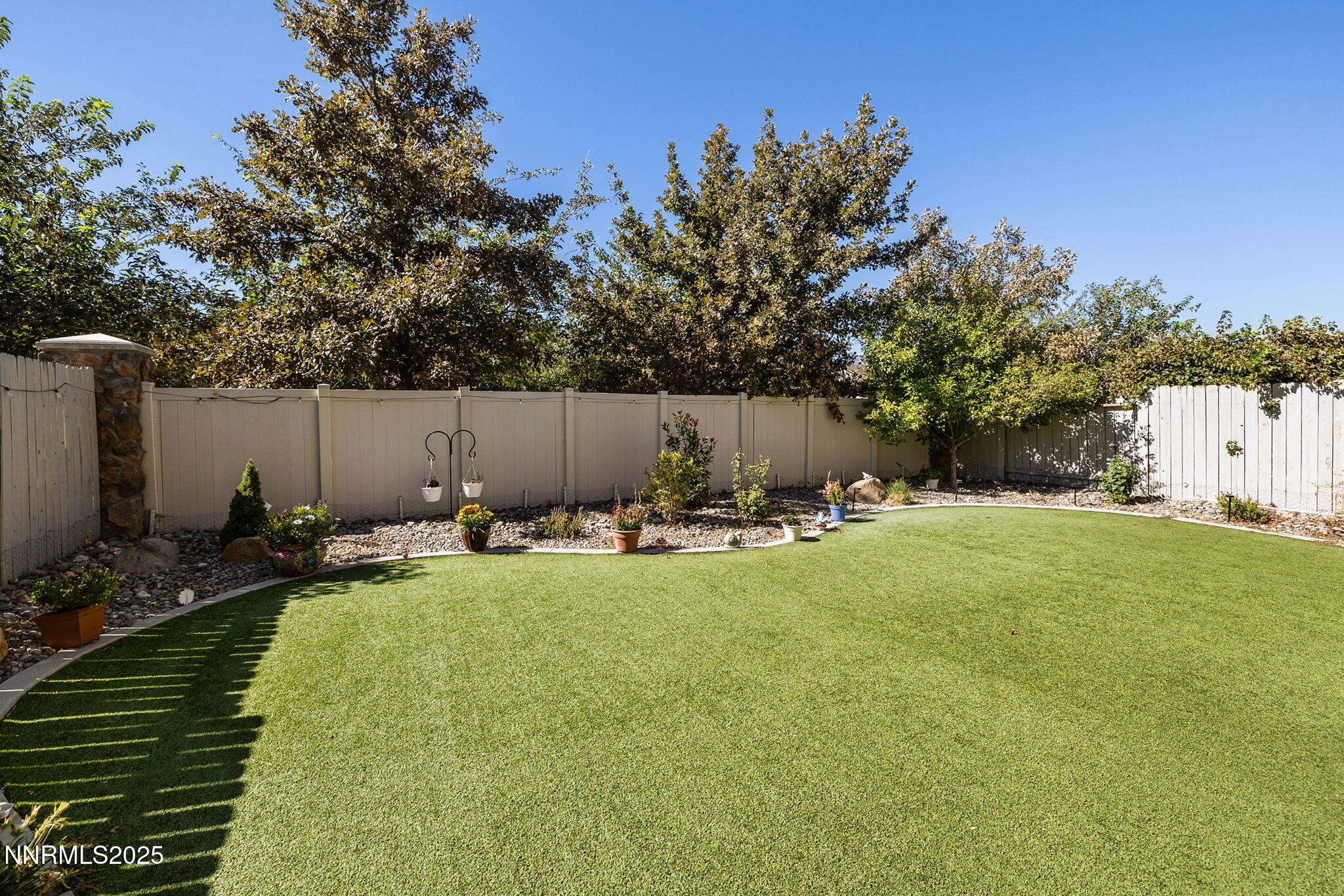 1876 Braemore Drive Reno, NV 89521 - Photo 32 of 34 a view of a backyard with table and chairs with a fire pit and a large tree