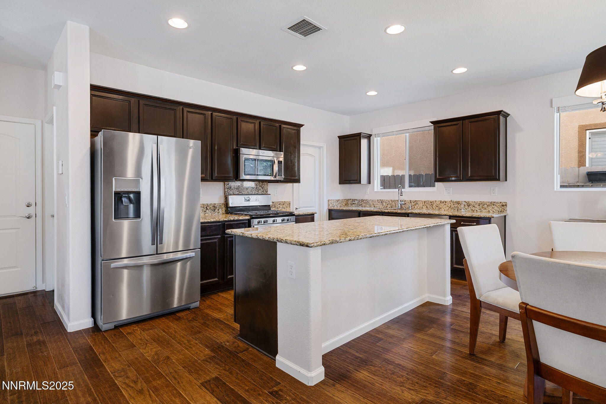 1876 Braemore Drive Reno, NV 89521 - Photo 9 of 34 a kitchen with stainless steel appliances granite countertop a refrigerator a stove a sink and a microwave