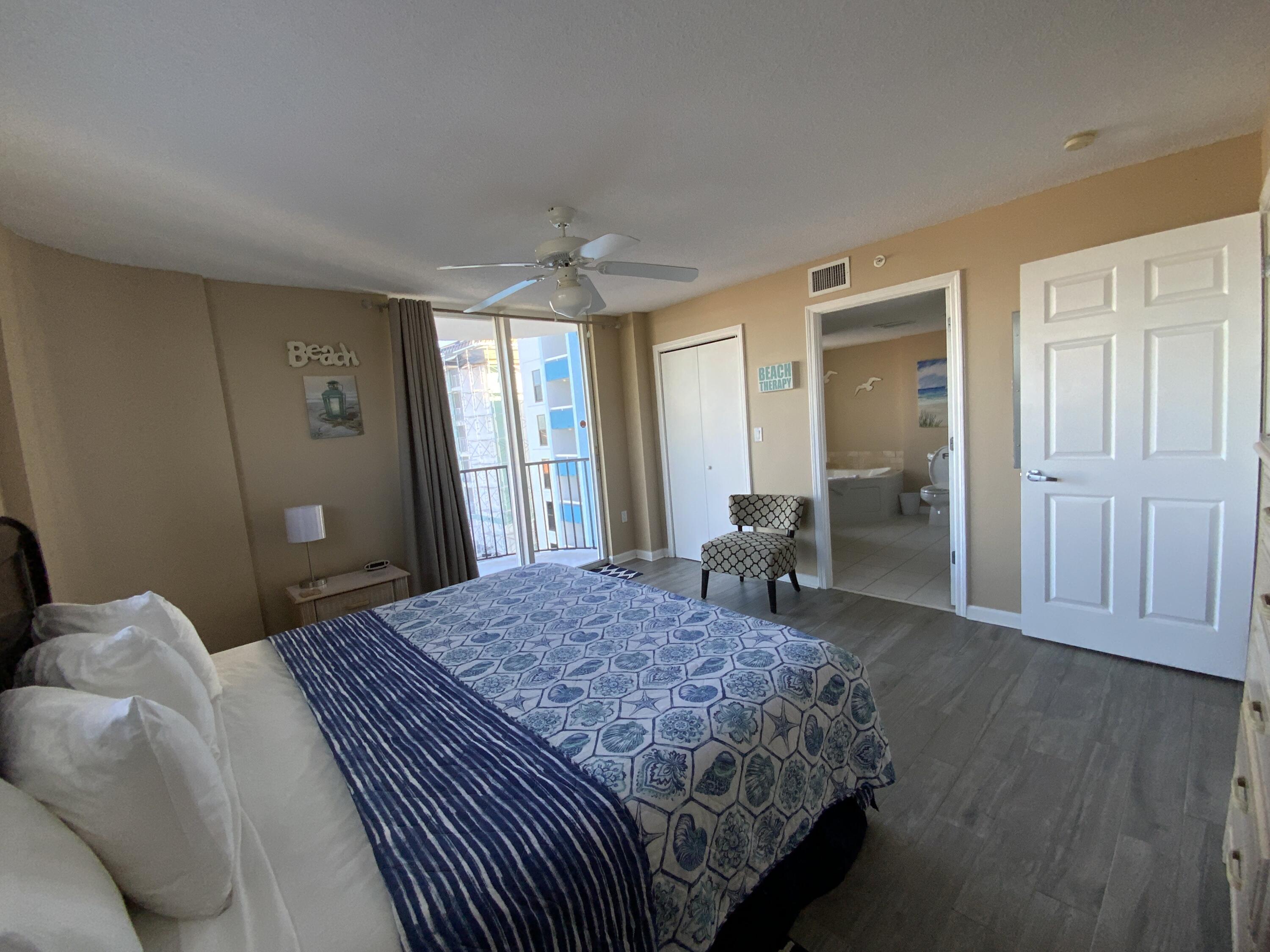 670 Santa Rosa Boulevard, Unit 503 Fort Walton Beach, FL 32548 - Photo 19 of 44 a bedroom with a large bed and wooden floor