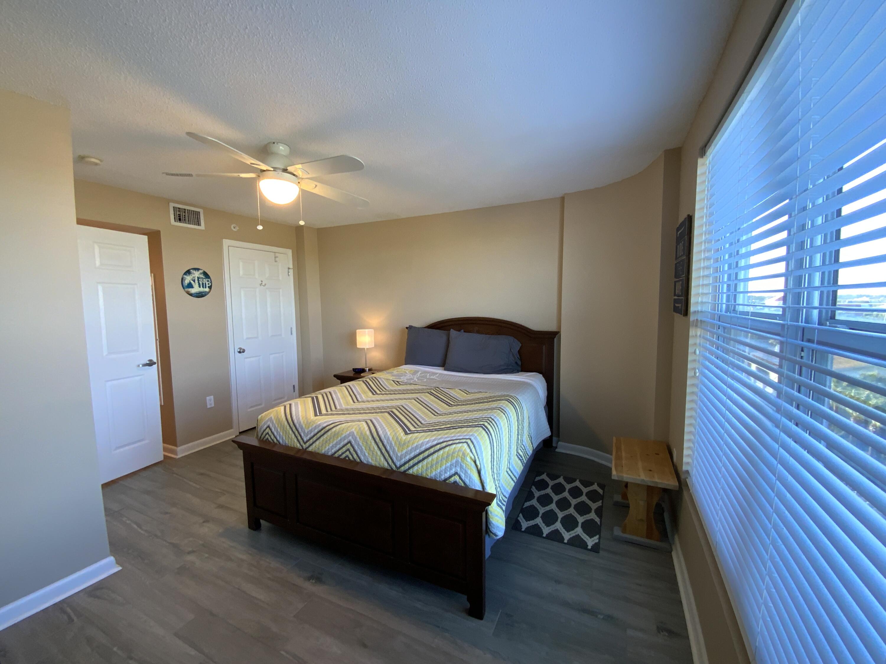670 Santa Rosa Boulevard, Unit 503 Fort Walton Beach, FL 32548 - Photo 30 of 44 a bedroom with a bed and wooden floor