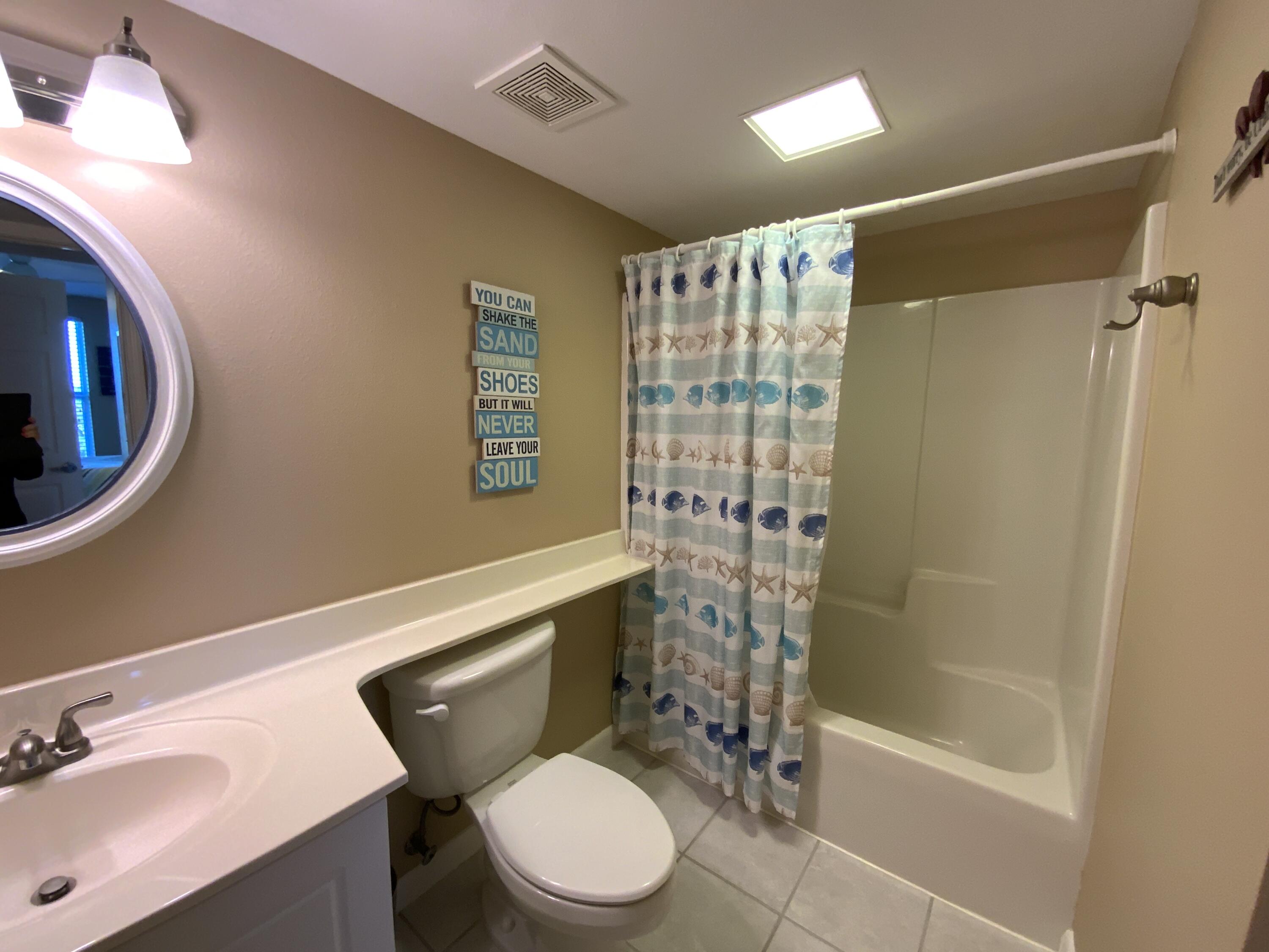670 Santa Rosa Boulevard, Unit 503 Fort Walton Beach, FL 32548 - Photo 33 of 44 a bathroom with a sink a toilet and shower