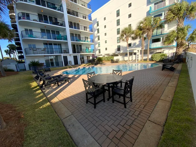 a swimming pool with outdoor seating and yard
