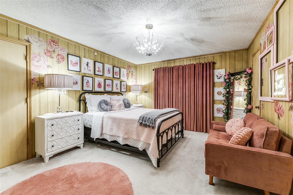 10615 Old Seagoville Road Dallas, TX 75217 - Photo 15 of 33 a spacious bedroom with a bed and a chandelier