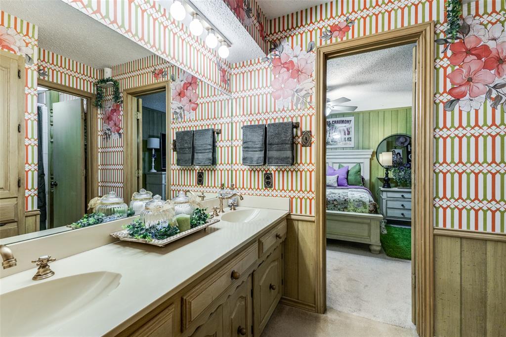 10615 Old Seagoville Road Dallas, TX 75217 - Photo 16 of 33 a en suite bathroom with a sink a mirror and next to a window