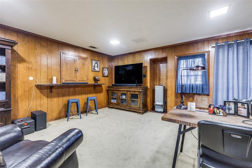 10615 Old Seagoville Road Dallas, TX 75217 - Photo 18 of 33 a living room with furniture and a flat screen tv
