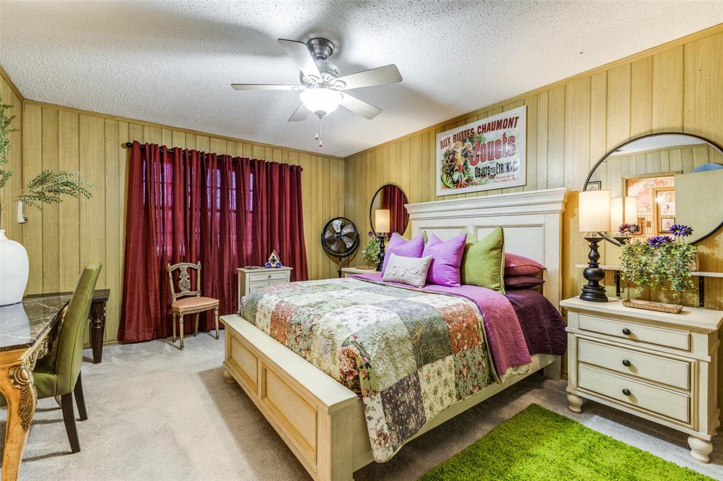 10615 Old Seagoville Road Dallas, TX 75217 - Photo 22 of 33 a bed room with a bed and a chandelier