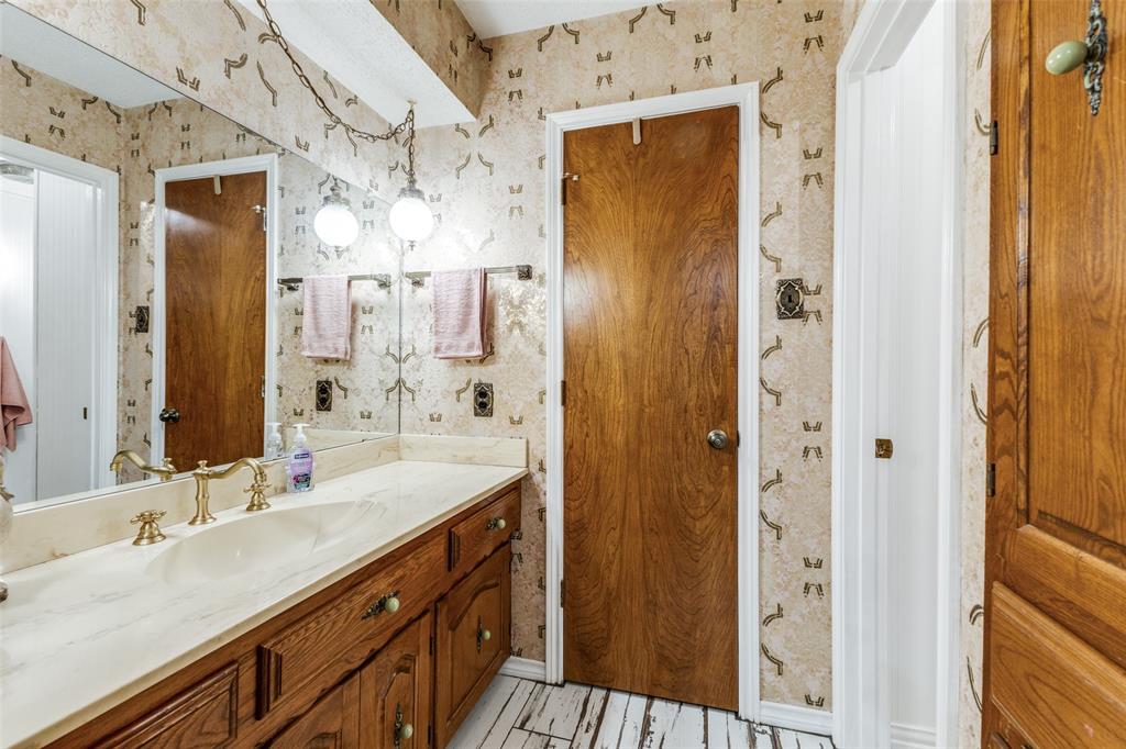 10615 Old Seagoville Road Dallas, TX 75217 - Photo 25 of 33 a bathroom with a double vanity sink mirror and shower