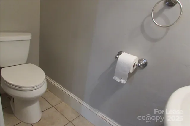 a white toilet sitting next to a white sink