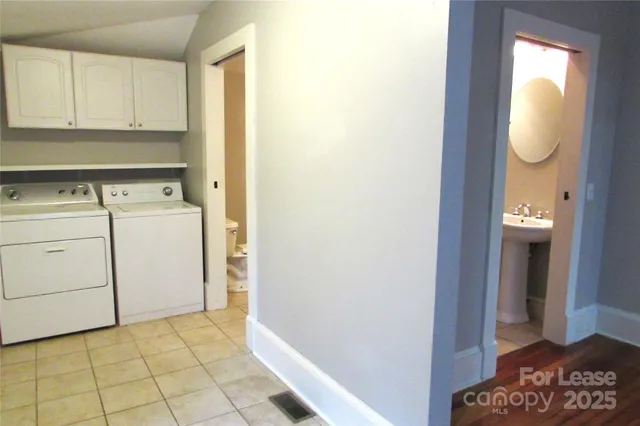 a view of a storage and utility room with washer and dryer