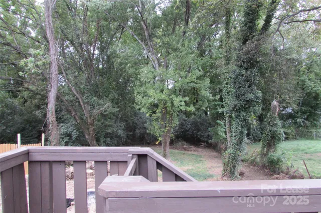 a view of a yard with large trees