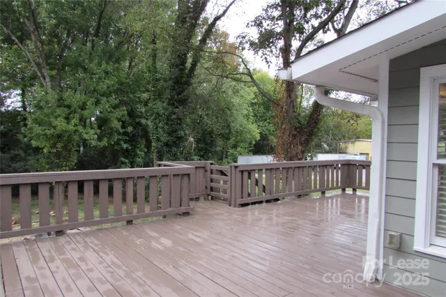 a view of balcony with wooden floor and fence