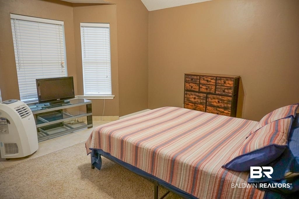 254 Thrift Street Mobile, AL 36609 - Photo 13 of 16 Tiled bedroom with baseboards and lofted ceiling