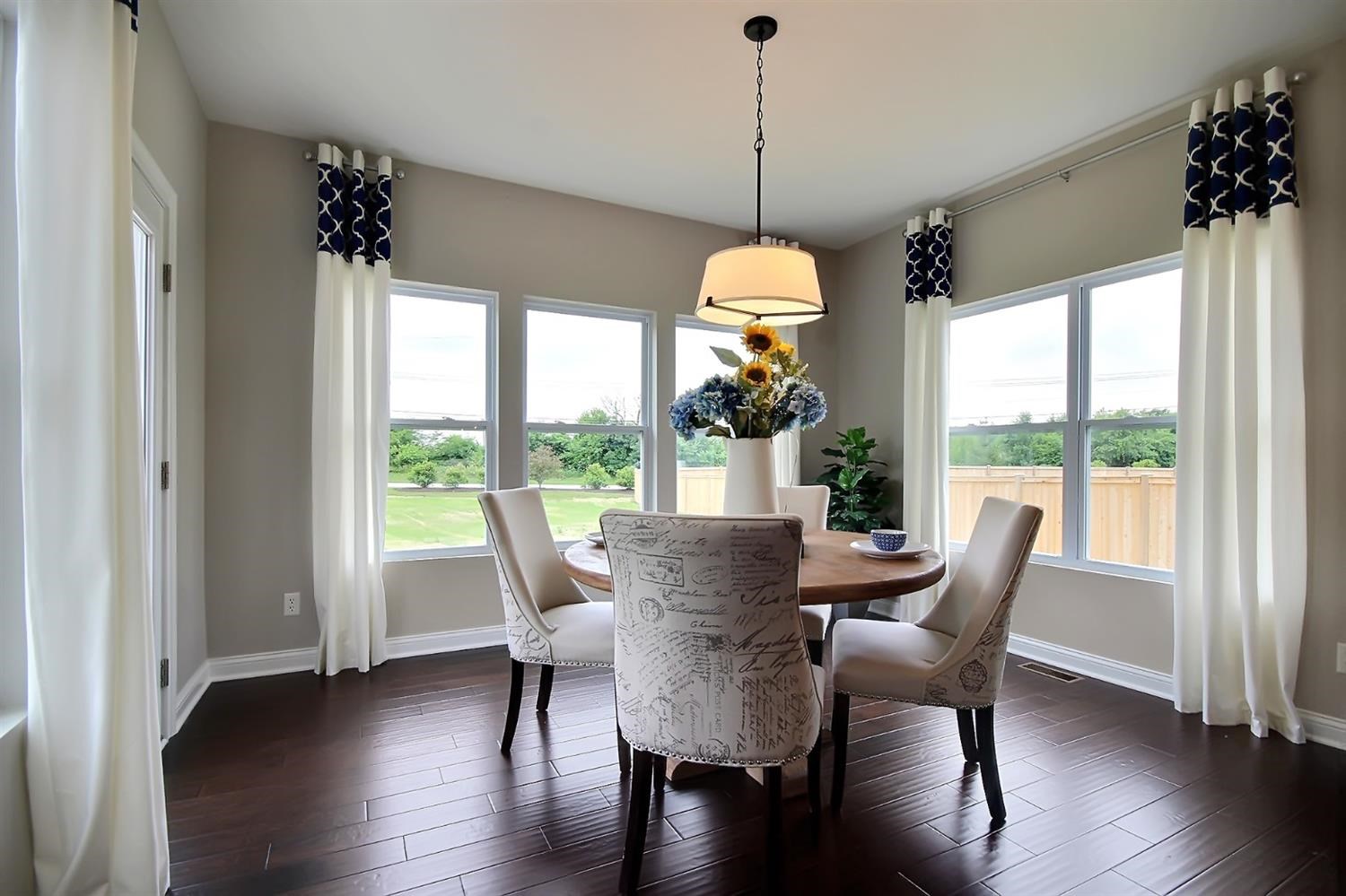 5740 Burr Rdg Circle Crown Point, IN 46307 - Photo 11 of 26 a view of a dining room with furniture window and wooden floor