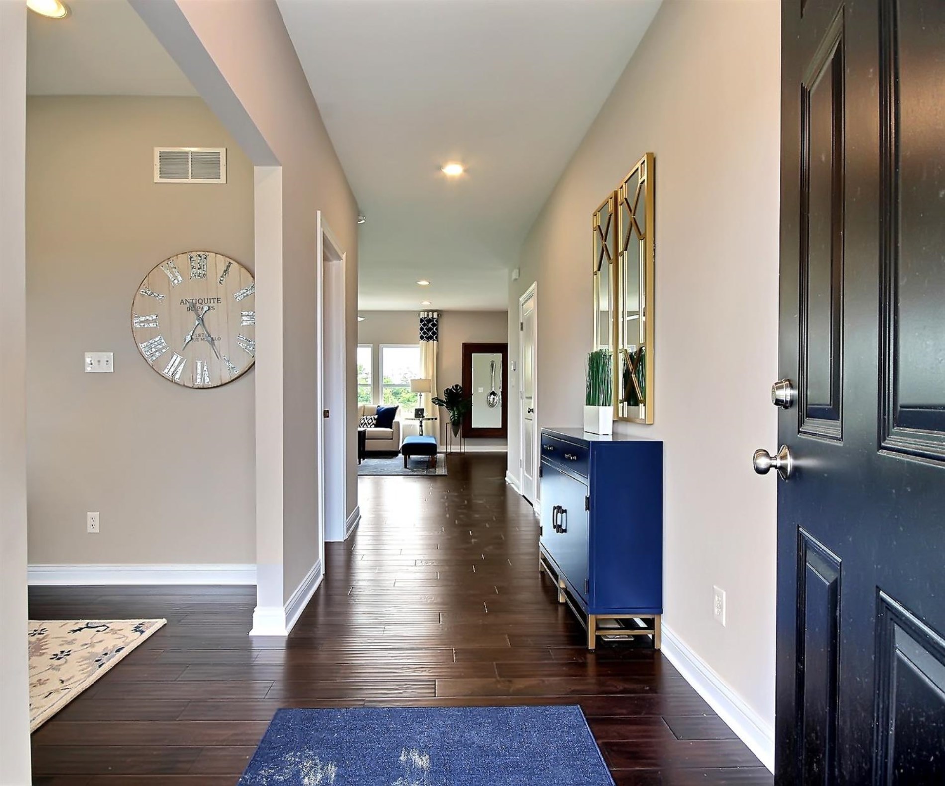 5740 Burr Rdg Circle Crown Point, IN 46307 - Photo 6 of 26 a view of a hallway with wooden floor and a bookshelf