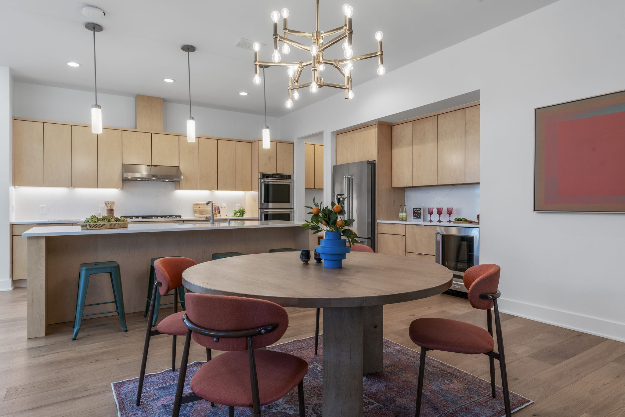 4602 Rue Street Austin, TX 78731 - Photo 23 of 39 a kitchen with kitchen island a dining table chairs and white cabinets