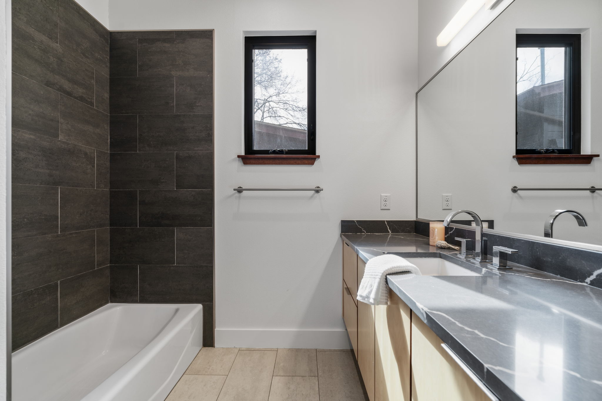 4602 Rue Street Austin, TX 78731 - Photo 30 of 39 a bathroom with a granite countertop sink a mirror and bathtub